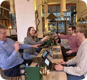 Kana Earth team working together at laptops in a café